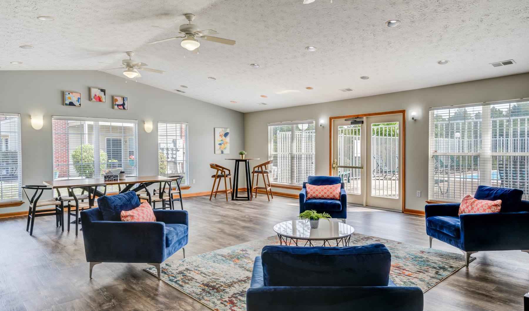 a large living room with blue couches and a table