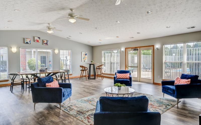 a large living room with blue couches and a table